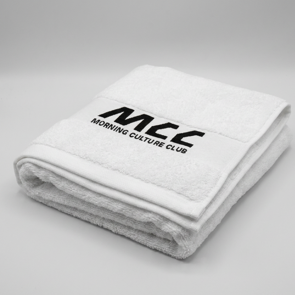 MCC 5-9 Active gym towel in white, folded, woven MCC wordmark on top