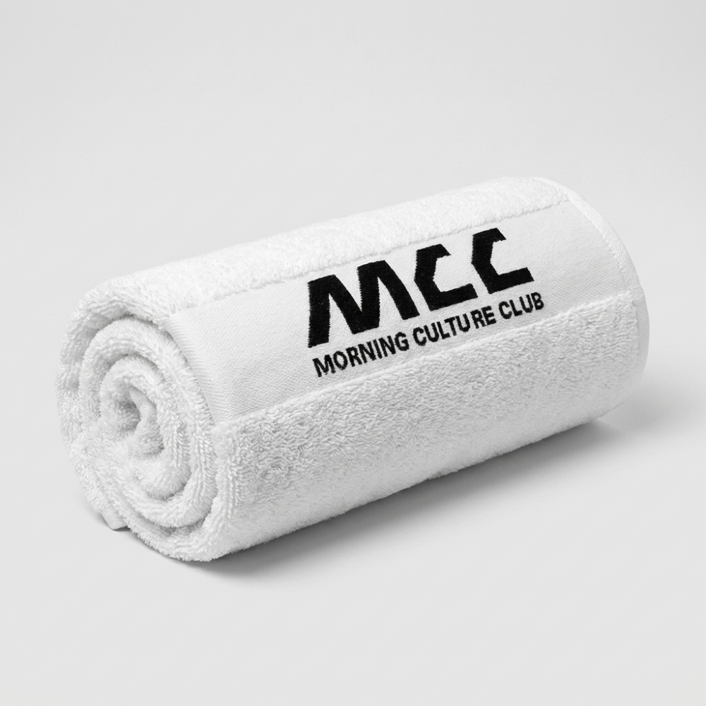 MCC 5-9 Active gym towel in white, rolled, woven MCC wordmark on the outside