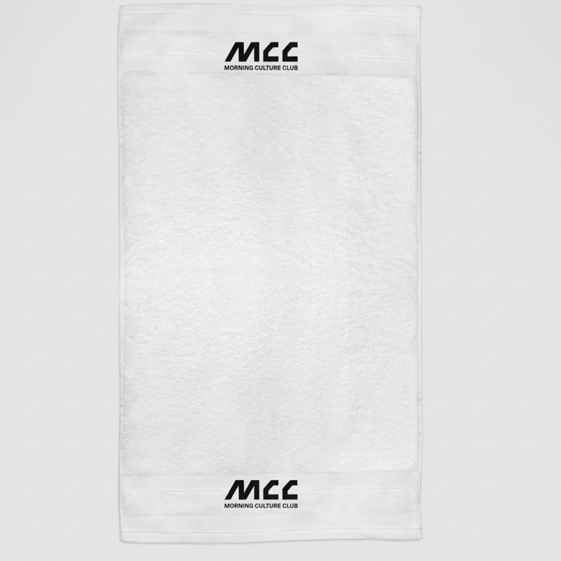 MCC 5-9 Active gym towel in white, flat lay, MCC wordmark woven into the border at both ends