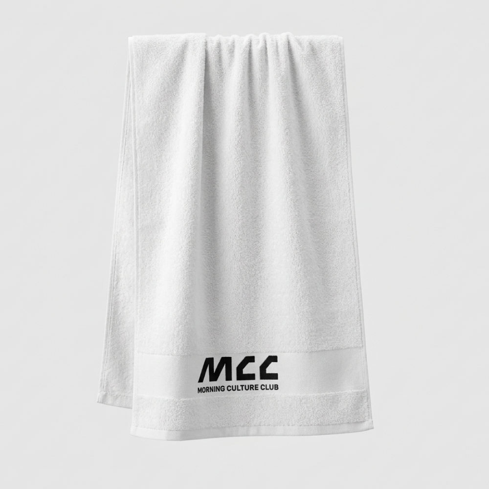 MCC 5-9 Active gym towel in white, hanging, woven MCC wordmark at the hem